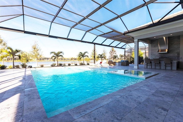 view of swimming pool featuring pool water feature, a patio area, a water view, glass enclosure, and an outdoor hangout area