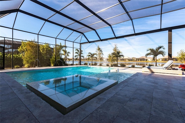 view of swimming pool with a patio, a lanai, pool water feature, and an in ground hot tub