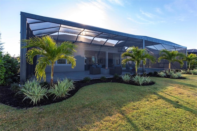 back of house with a yard, a lanai, and a patio area