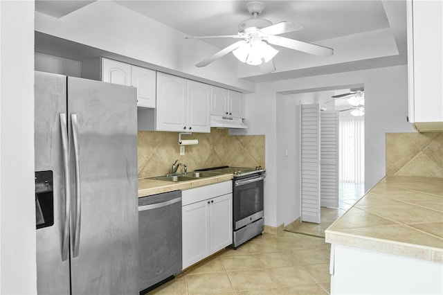 kitchen with tasteful backsplash, stainless steel appliances, and white cabinets