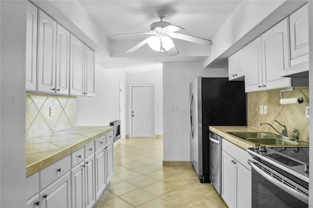 kitchen with white cabinetry, ceiling fan, stainless steel appliances, and sink