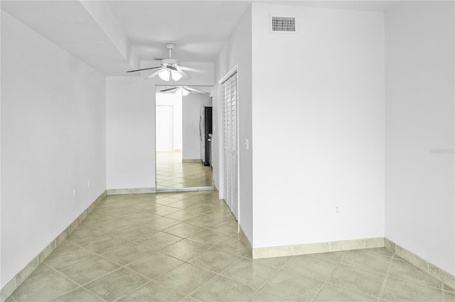 spare room featuring light tile patterned flooring and ceiling fan