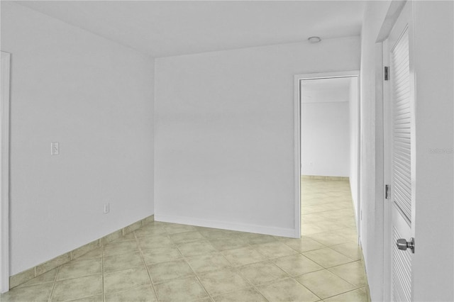 spare room featuring light tile patterned flooring