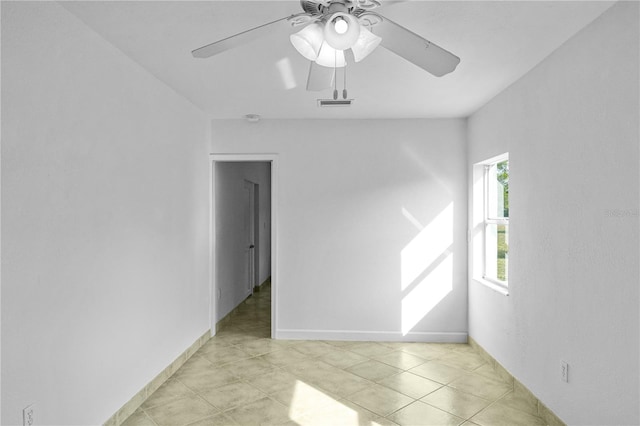 tiled empty room with ceiling fan