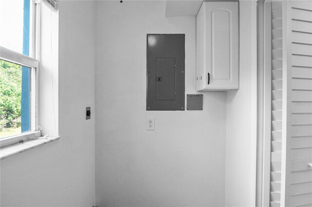1226 Coral Ridge Dr, Punta Gorda, FL 33950 - laundry room featuring electric panel, electric dryer hookup, and cabinet space