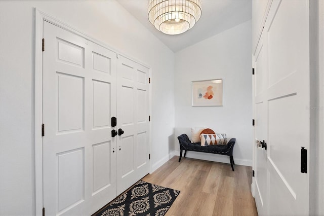 entrance foyer with lofted ceiling and light wood-type flooring