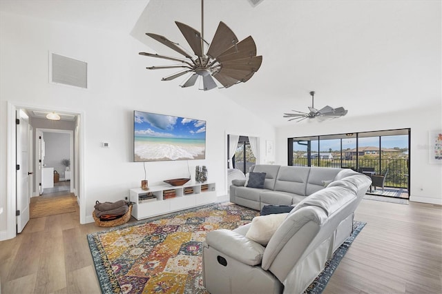 living room featuring high vaulted ceiling, light hardwood / wood-style floors, and ceiling fan