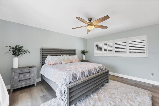 bedroom with hardwood / wood-style flooring and ceiling fan