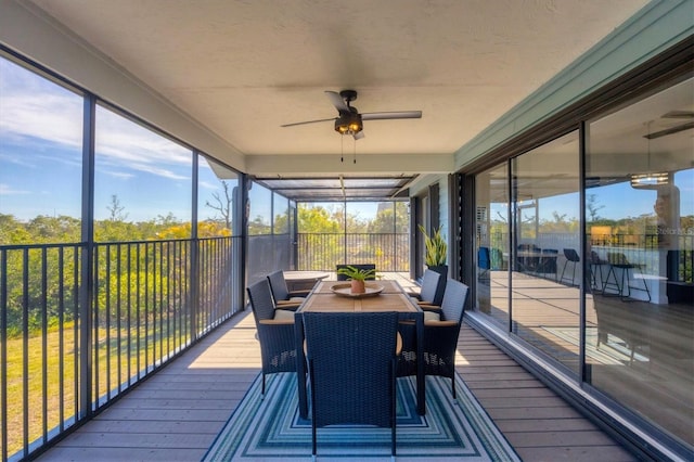 sunroom / solarium featuring ceiling fan and a wealth of natural light