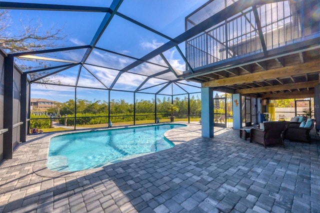 view of swimming pool featuring a lanai, an outdoor hangout area, and a patio