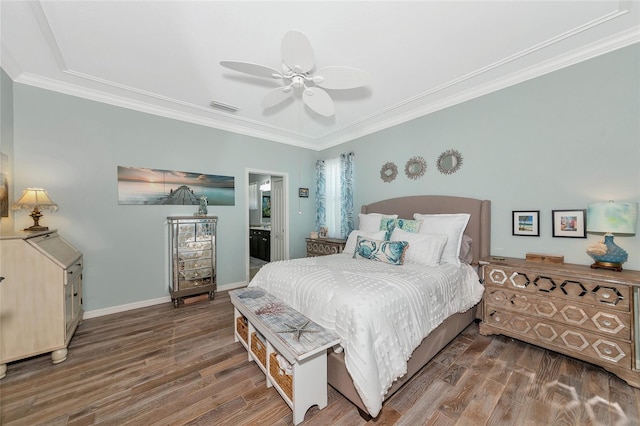 bedroom featuring connected bathroom, crown molding, dark wood-type flooring, and ceiling fan