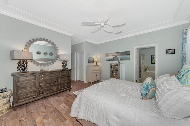 bedroom featuring crown molding, wood-type flooring, and ceiling fan