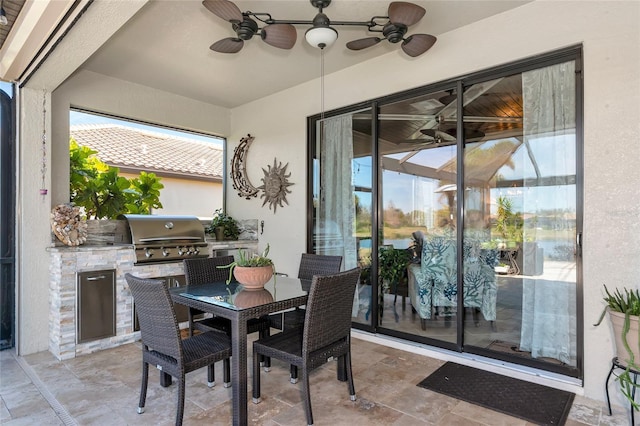 view of patio / terrace featuring ceiling fan, area for grilling, and a grill