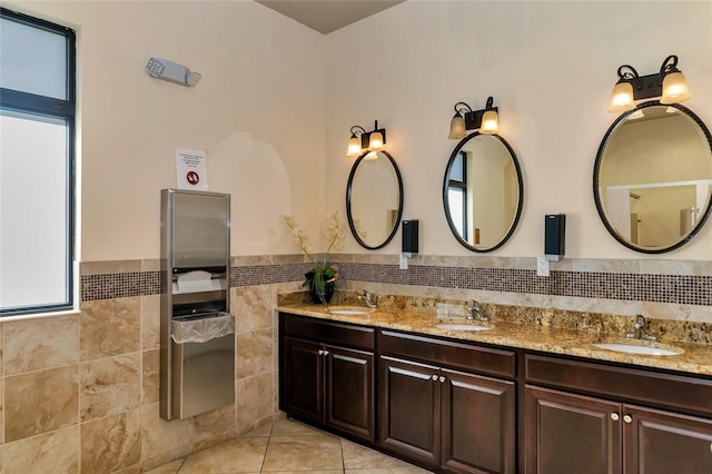 bathroom with tile patterned flooring, vanity, and tile walls