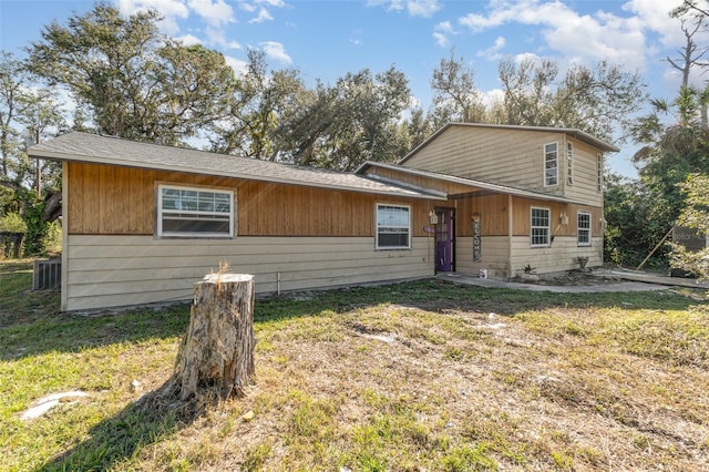 view of front of home featuring central AC and a front lawn