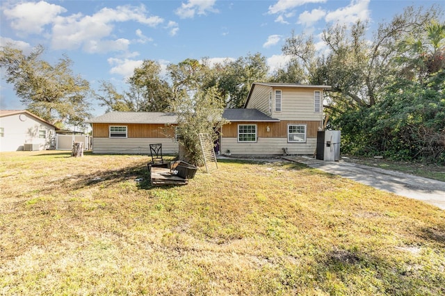 rear view of property with a yard