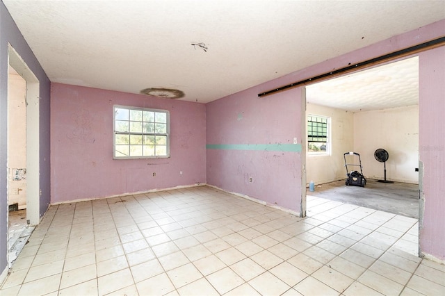 empty room featuring a barn door and plenty of natural light