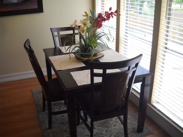 dining space with dark wood-type flooring