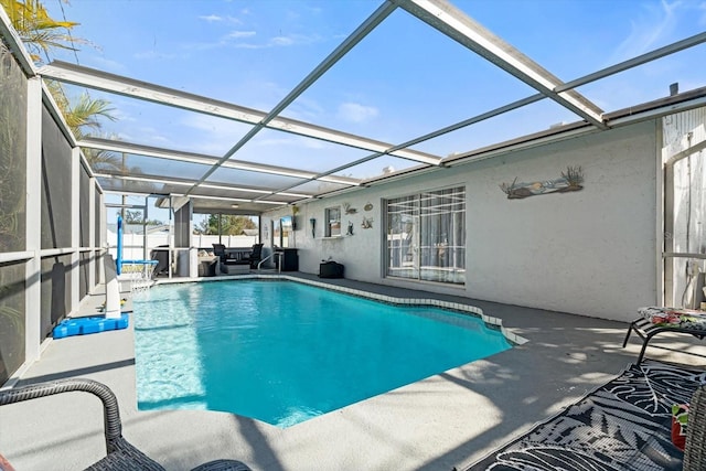 view of swimming pool with a patio and glass enclosure