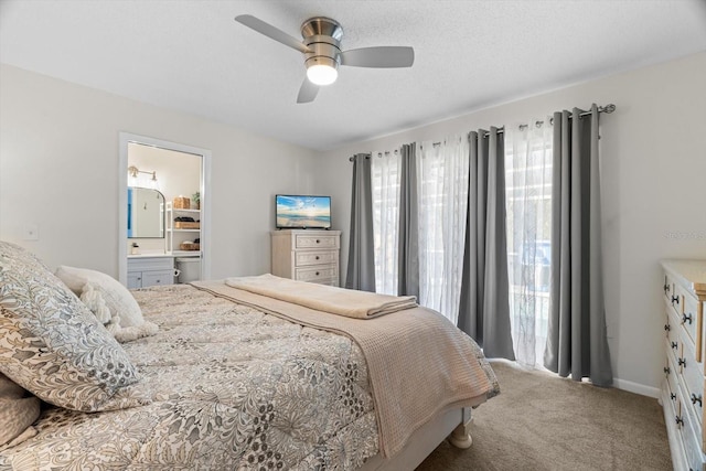 bedroom featuring ceiling fan, carpet, connected bathroom, and a textured ceiling