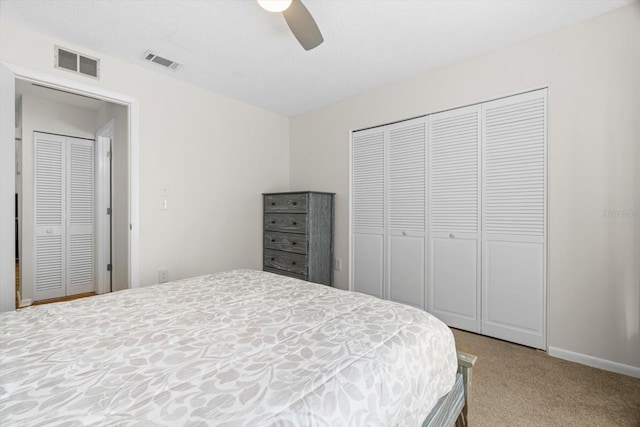 carpeted bedroom featuring ceiling fan and a closet