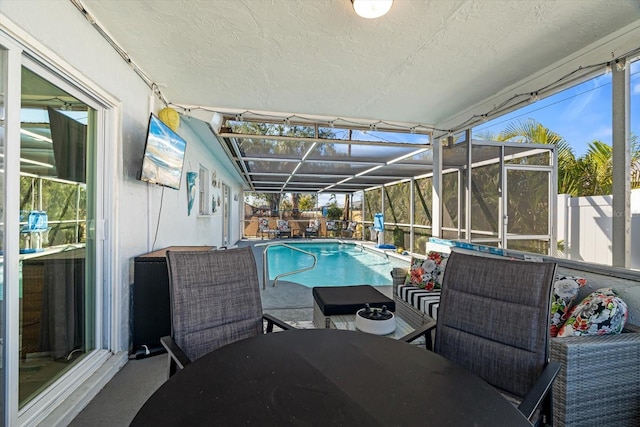 view of swimming pool featuring a lanai