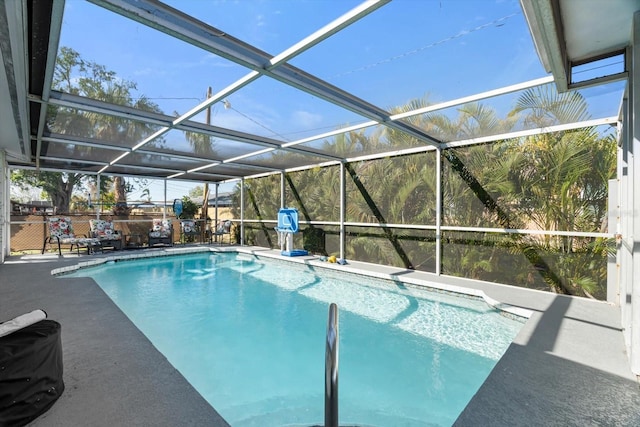 view of pool featuring glass enclosure and a patio area