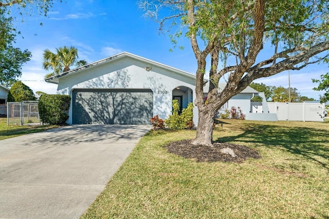 ranch-style home with a garage and a front yard