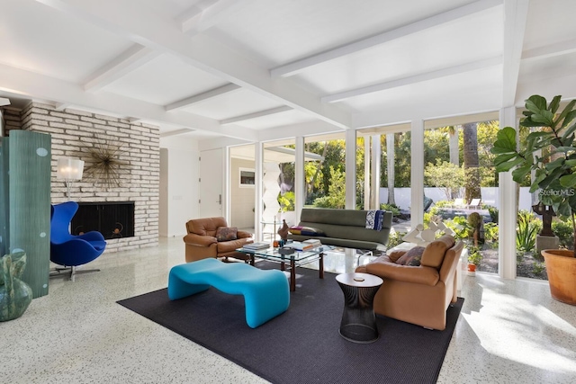 sunroom featuring beam ceiling and a fireplace