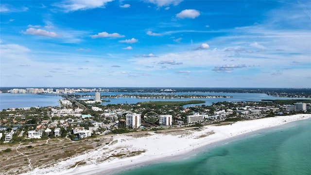 birds eye view of property with a water view and a view of the beach