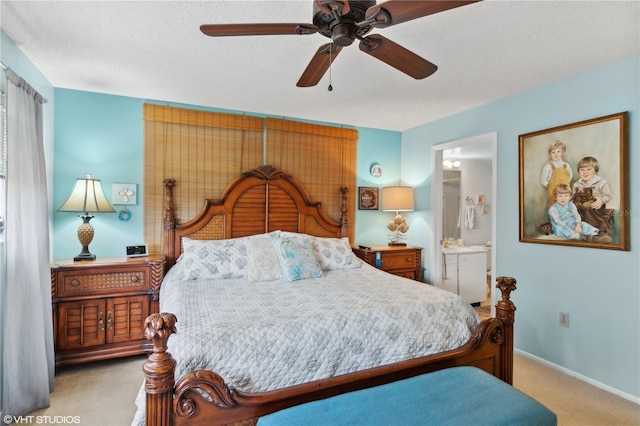 bedroom featuring light colored carpet, ensuite bathroom, and a textured ceiling