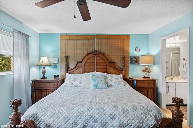 bedroom featuring sink, ensuite bathroom, a textured ceiling, and ceiling fan