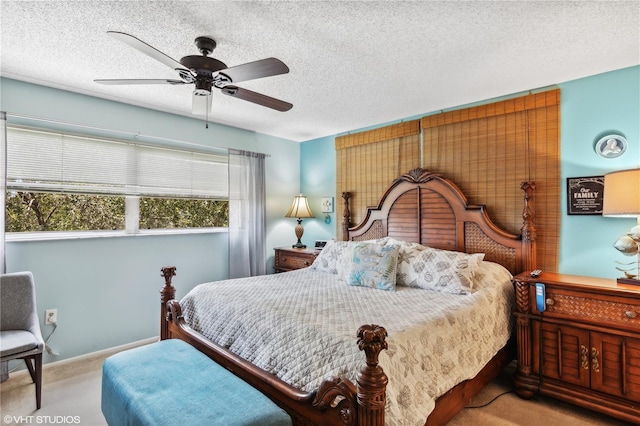 carpeted bedroom featuring ceiling fan and a textured ceiling