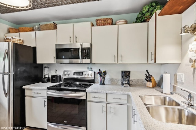 kitchen with white cabinetry, sink, and appliances with stainless steel finishes