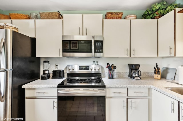 kitchen featuring appliances with stainless steel finishes and white cabinets