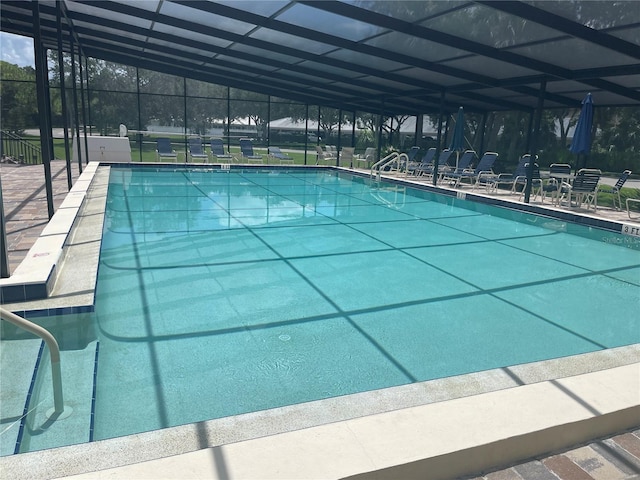 view of swimming pool with glass enclosure