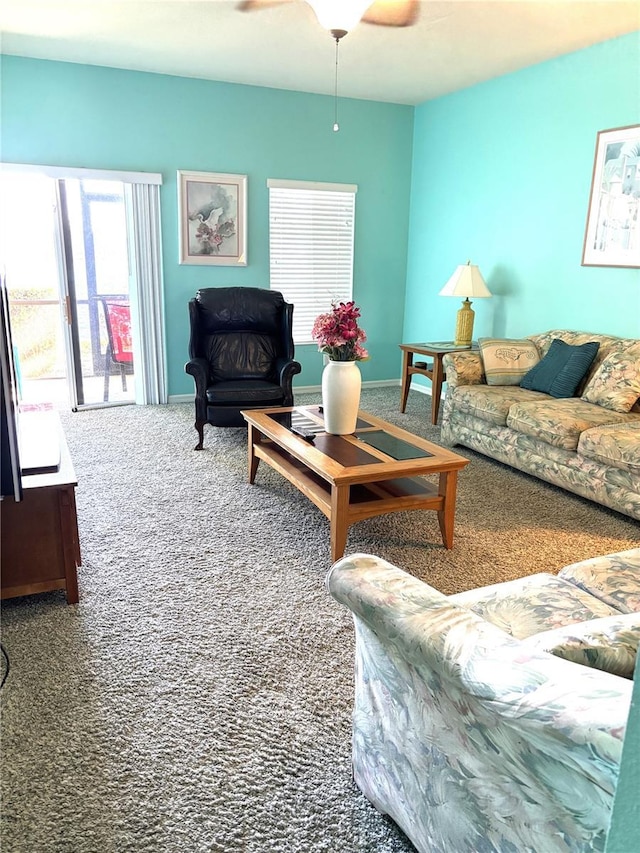 carpeted living room featuring ceiling fan