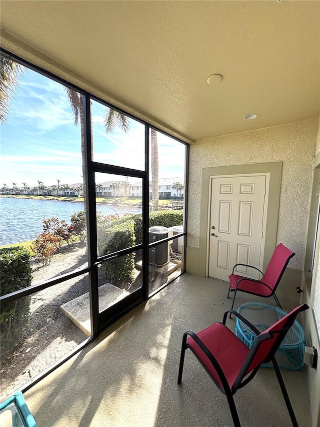 sunroom / solarium with a water view