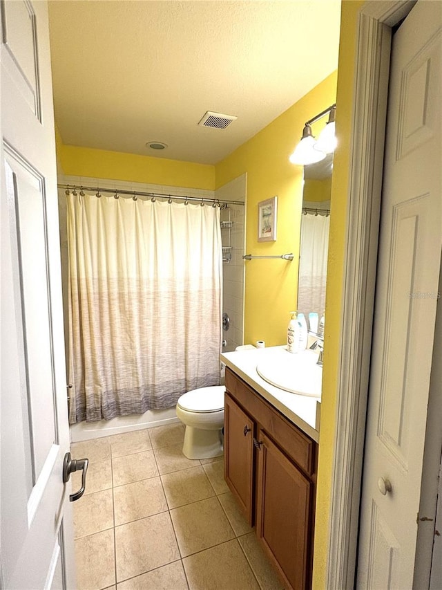 full bathroom with shower / tub combo with curtain, tile patterned floors, toilet, a textured ceiling, and vanity