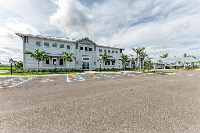 view of building exterior with uncovered parking