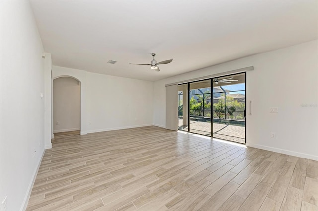 unfurnished room with ceiling fan, visible vents, a sunroom, baseboards, and light wood finished floors