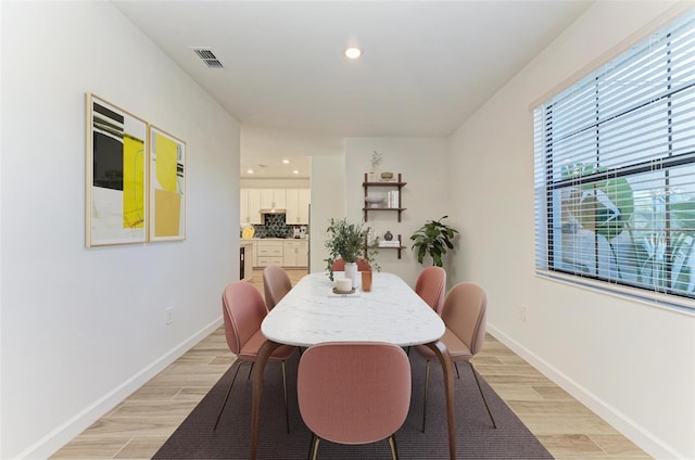 dining space featuring baseboards, visible vents, light wood-style flooring, and recessed lighting