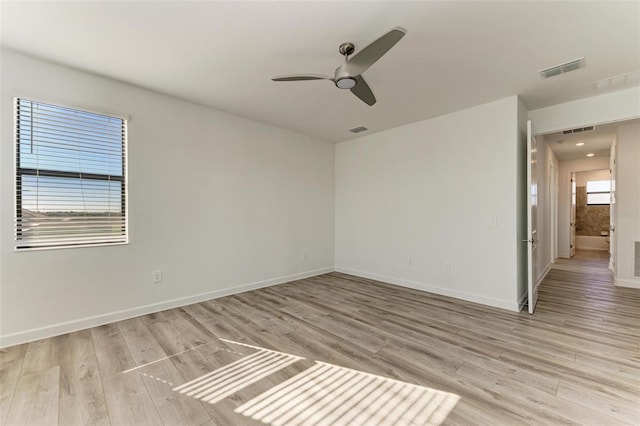 empty room featuring light wood-type flooring and visible vents