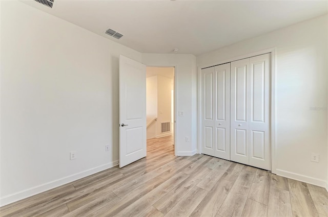 unfurnished bedroom featuring light wood-type flooring, visible vents, and baseboards