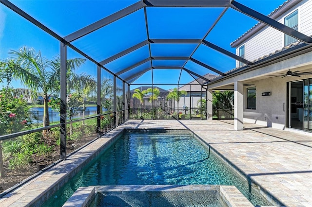 view of pool featuring a pool with connected hot tub, a patio area, glass enclosure, and ceiling fan