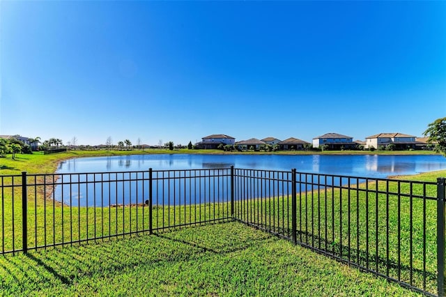 view of water feature featuring a residential view and fence