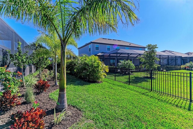 view of yard featuring a lanai and a fenced backyard