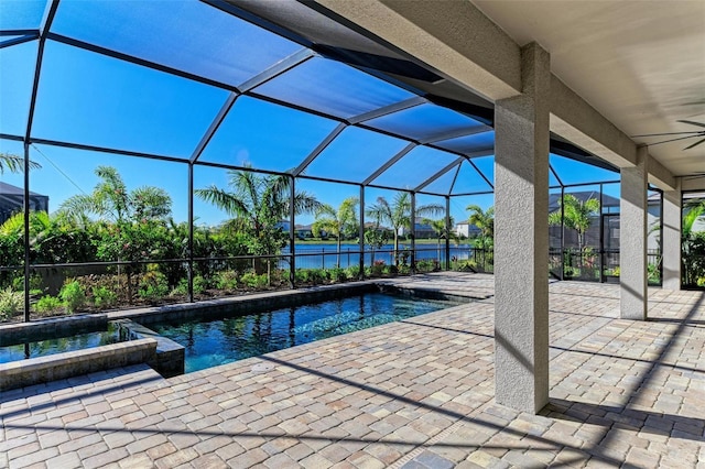 pool with a ceiling fan, a lanai, a water view, and a patio