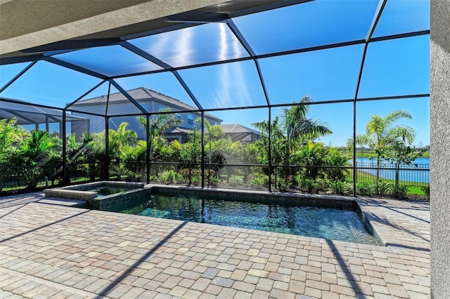 view of swimming pool with a patio, a lanai, a water view, fence, and a pool with connected hot tub