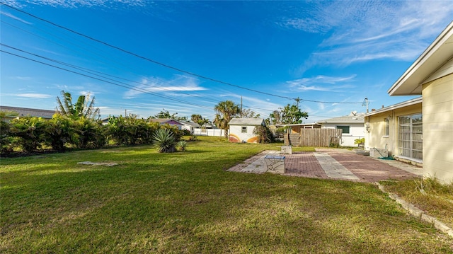 view of yard with a shed and a patio area